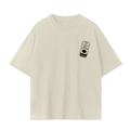 An cream short-sleeve crewneck t-shirt with a small graphic print on the left chest depicting a canned seafood.