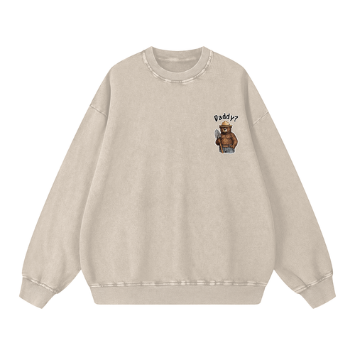 A light beige crewneck sweatshirt with a small graphic on the left chest showing an outdoor bear wearing a hat and the text 'Daddy?'.