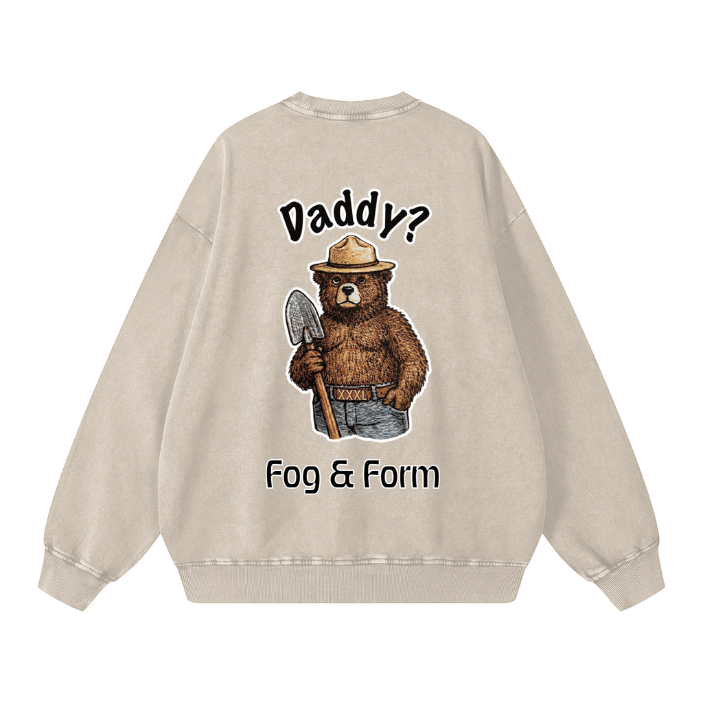 A beige crewneck sweatshirt shown from the back, featuring a graphic of a cartoon bear wearing a ranger hat and holding a shovel, with the text 'Daddy?' above and 'Fog & Form' below.