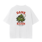 A white crew t-shirt with a graphic on the front featuring a cartoon green cannabis bud wearing sunglasses and smoking a joint, with the text 'DANK KUSH' in red above and below, and 'FOG & FORM' underneath.