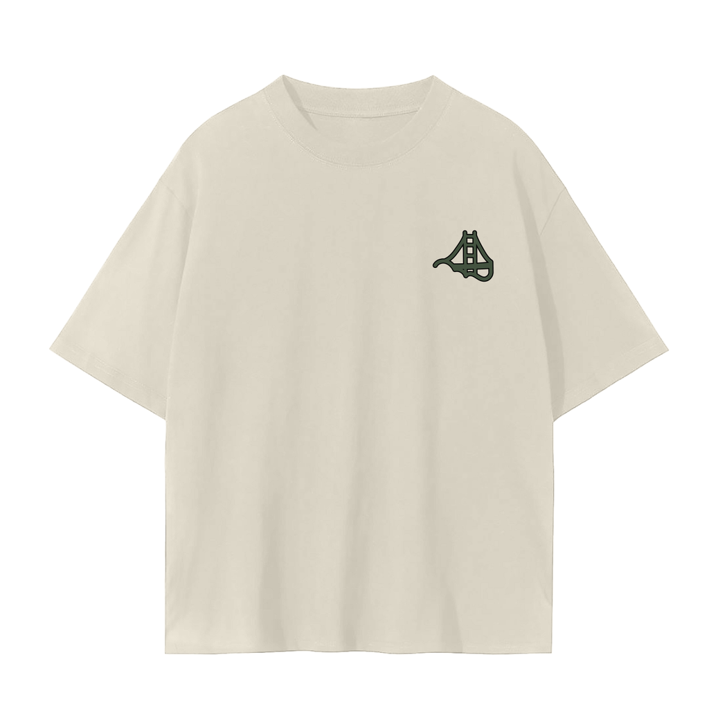 An cream short sleeve t-shirt with a small dark green Fog & Form logo of the Golden Gate Bridge on the left chest.