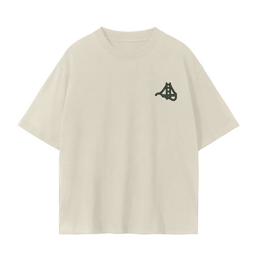 An cream short sleeve t-shirt with a small dark green Fog & Form logo of the Golden Gate Bridge on the left chest.