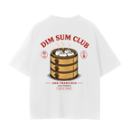 A white short-sleeve t-shirt with a large graphic print on the back featuring a wooden dim sum steamer basket, dumplings, and red text reading 'DIM SUM CLUB'.