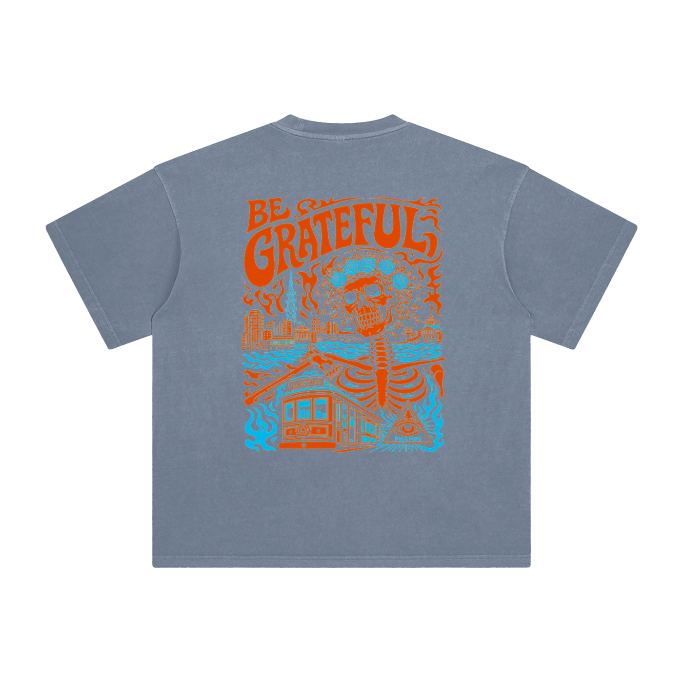 A washed blue short-sleeve t-shirt shown from the back, featuring a large orange and light blue graphic print of a skeleton, a cable car, and the words 'BE GRATEFUL'.
