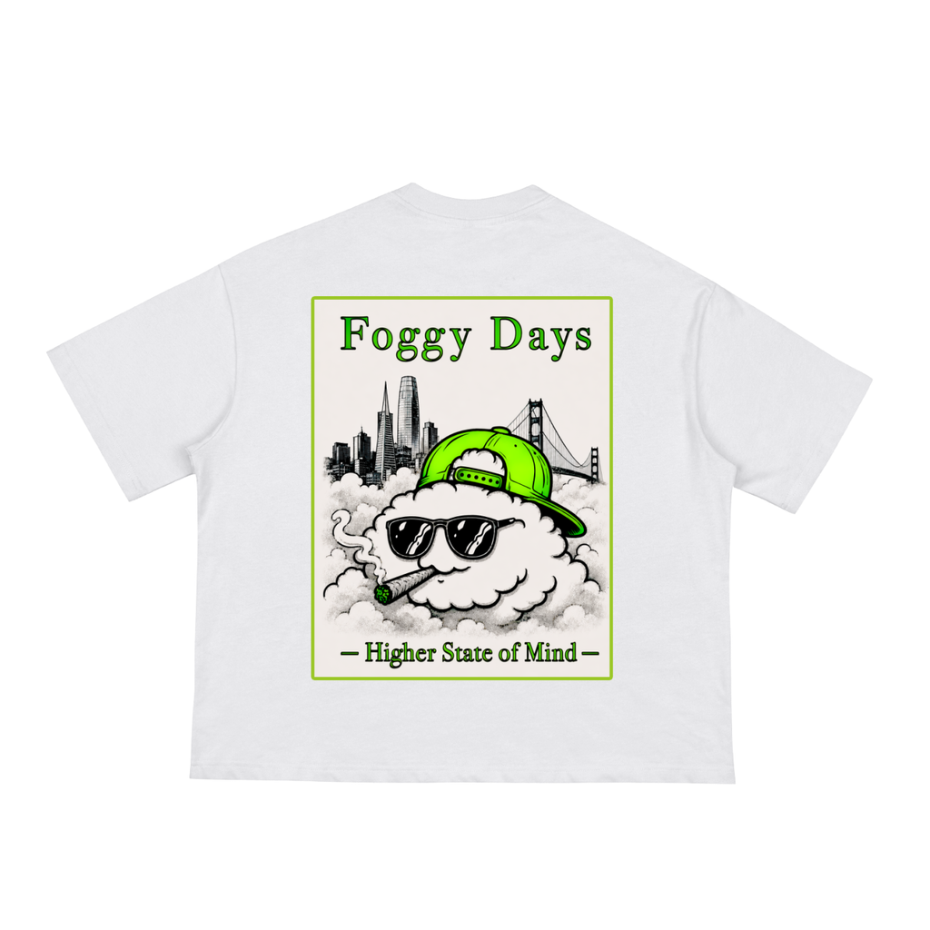 A white short-sleeve t-shirt with the graphic of Karl the Fog wearing a green cap and sunglasses, smoking, with a city skyline and Golden Gate Bridge in the background.